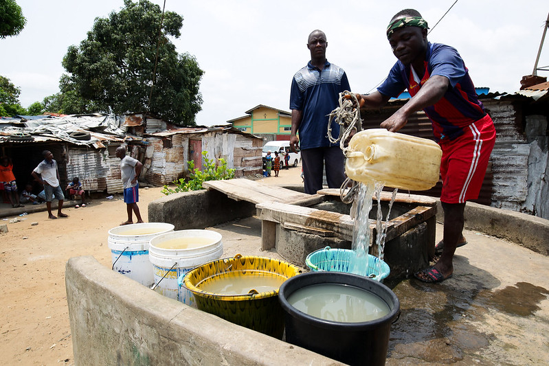 Men fetching water in Monrovia, Liberia